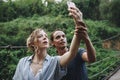 Caucasian woman and man taking a selfie outdoors recreational leisure, freedom and adventure concept