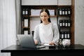 Caucasian Women are putting coins in a piggy bank for a business that grows for profit and saving money for the future. planning Royalty Free Stock Photo