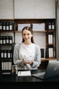 Caucasian Women are putting coins in a piggy bank for a business that grows for profit and saving money for the future. planning Royalty Free Stock Photo