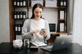 Caucasian Women are putting coins in a piggy bank for a business that grows for profit and saving money for the future. planning Royalty Free Stock Photo