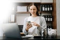 Caucasian Women are putting coins in a piggy bank for a business that grows for profit and saving money for the future. planning Royalty Free Stock Photo