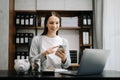 Caucasian Women are putting coins in a piggy bank for a business that grows for profit and saving money for the future. planning Royalty Free Stock Photo