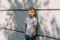 Caucasian 7 years old boy near gray wall Royalty Free Stock Photo