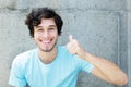 Caucasian young adult man with blue eyes showing thumb up Royalty Free Stock Photo