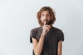 Caucasian young bearded man make silence gesture.