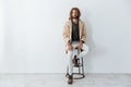Caucasian young bearded man sitting isolated over grey wall Royalty Free Stock Photo