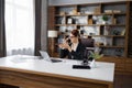 Caucasian young beautiful businesswoman talking on mobile phone while working on laptop Royalty Free Stock Photo