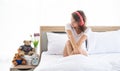 Caucasian young and beautiful happy woman with headphone sitting on the  comfortable  double bed in the modern bedroom Royalty Free Stock Photo