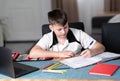 Caucasian young boy concentrated on doing his homework Royalty Free Stock Photo