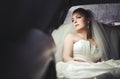 Caucasian young bride sitting in limo. Royalty Free Stock Photo