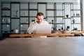 Caucasian young business man wearing fashion casual clothing working on laptop and talking on phone Royalty Free Stock Photo