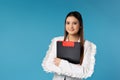 Caucasian young business woman with folder of documents isolated on blue studio background. Young entrepreneurship Royalty Free Stock Photo