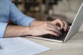 Caucasian young businessman working at laptop, typing on keyboard Royalty Free Stock Photo