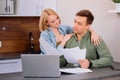 Caucasian young couple reading and analyzing bills sitting at table Royalty Free Stock Photo