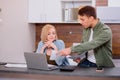 Caucasian young couple reading and analyzing bills sitting at table Royalty Free Stock Photo