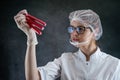 caucasian young doctor in white coat looking a test tube with blood sample isolated on black Royalty Free Stock Photo