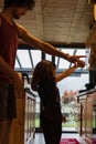 Young father and child girl dancing in the kitchen. Vertical shot Royalty Free Stock Photo