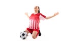 Caucasian young female player with arms outstretched kneeling by soccer ball over white background Royalty Free Stock Photo