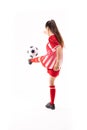 Caucasian young female soccer player kicking soccer ball against white background with copy space Royalty Free Stock Photo