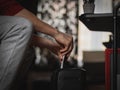 A caucasian young man is destroying documents in a black shredder Royalty Free Stock Photo