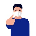 Caucasian young man with disposable face mask and showing thumb up. Protection versus viruses and infection. Respiratory mask for