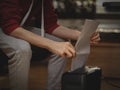 Caucasian young man inserts a sheet of paper for destruction in a black shredder Royalty Free Stock Photo