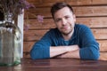 Caucasian young man smiling outside sitting on terrace. Royalty Free Stock Photo