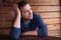 Caucasian young man smiling outside sitting on terrace. Royalty Free Stock Photo