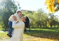 Caucasian young mother playing throwing up in air cute funny adorable toddler boy. Mom and son having fun in autumn fall Royalty Free Stock Photo