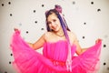 Caucasian young woman with dreadlocks hairstyle wearing pink dress, doll style, bright make up Royalty Free Stock Photo