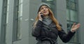 Caucasian young stylish redhead woman talking on cellphone in the morning at street. Beautiful happy female speaking on Royalty Free Stock Photo