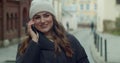 Caucasian young stylish woman talking on cellphone in the morning at street. Beautiful happy female speaking on mobile Royalty Free Stock Photo