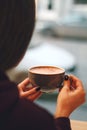 Caucasian young woman enjoying coffee drinking in cafe, close up Royalty Free Stock Photo