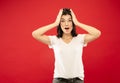 Caucasian young woman`s half-length portrait on red background Royalty Free Stock Photo