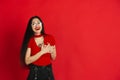 Caucasian young woman`s monochrome portrait on red studio background, emotional and expressive Royalty Free Stock Photo