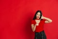 Caucasian young woman`s monochrome portrait on red studio background, emotional and expressive Royalty Free Stock Photo