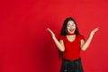 Caucasian young woman`s monochrome portrait on red studio background, emotional and expressive Royalty Free Stock Photo