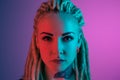 Caucasian young woman`s portrait on gradient background in neon light Royalty Free Stock Photo
