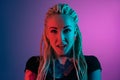 Caucasian young woman`s portrait on gradient background in neon light Royalty Free Stock Photo