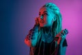 Caucasian young woman`s portrait on gradient background in neon light Royalty Free Stock Photo