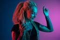 Caucasian young woman`s portrait on gradient background in neon light Royalty Free Stock Photo