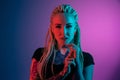 Caucasian young woman`s portrait on gradient background in neon light Royalty Free Stock Photo