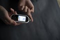 Caucasian young woman using digital glucometer at home. Royalty Free Stock Photo