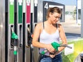 Woman filling up tank of her car with gasoline Royalty Free Stock Photo