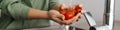 Caucasian woman washing tomatoes at home kitchen Royalty Free Stock Photo