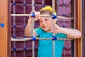 Caucasoid sporty cheerful boy playing on a wooden Playground