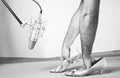 Caucassian man hand inside femail shoes front a proffesional studio microphone. Black and white Royalty Free Stock Photo