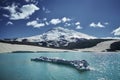 Caucasus Elbrus majestic mountain peak, blue sky lake, snow covered glacier, rocky landscape, alpine scenery Royalty Free Stock Photo