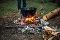 A cauldron for cooking is on the fire