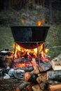 A cauldron for cooking is on the fire Royalty Free Stock Photo